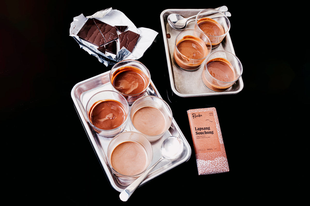 Two trays of hot chocolate samples and a Lapsang Souchong Raaka bar, open and broken into pieces.