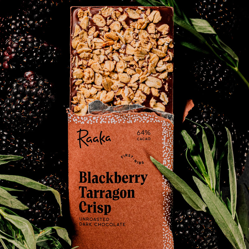 Raaka Blackberry Tarragon Crisp chocolate bar with blackberries and tarragon leaves on a dark background