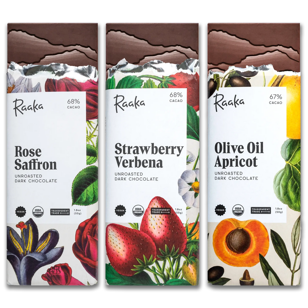 Three Raaka chocolate bars with different flavors on a white background: Rose Saffron, Strawberry Verbena, Olive Oil Apricot