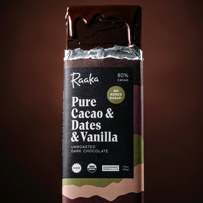 Pure Cacao & Dates & Vanilla bar with chocolate dripping down on a dark brown background.