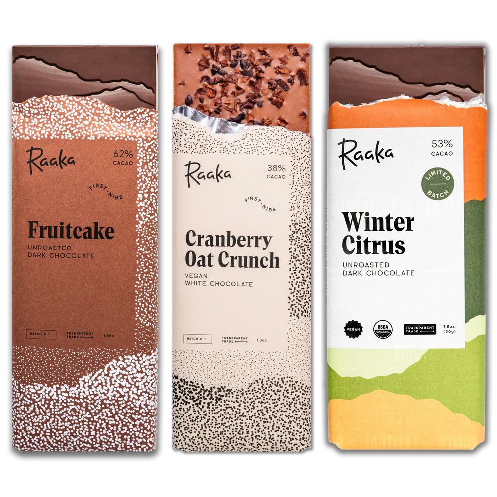 Three Raaka chocolate bars from the First Nibs subscription with different flavors and designs on a white background