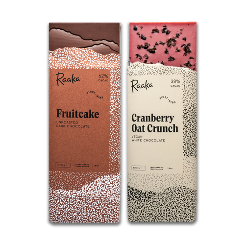 Two Raaka chocolate bars, one fruitcake and one cranberry oat crunch, on a white background.