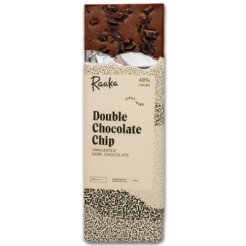 A packaged double chocolate chip bar by Raaka, showing the top half of the chocolate bar and the printed wrapper with cream, black speckling, and dark chocolate imagery.