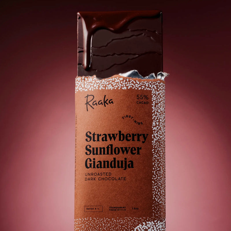 Strawberry Sunflower Gianduja bar in packaging on a red background