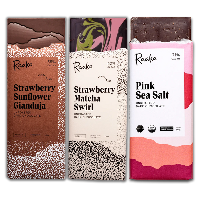 Three Raaka chocolate bars with different flavors on their packaging.