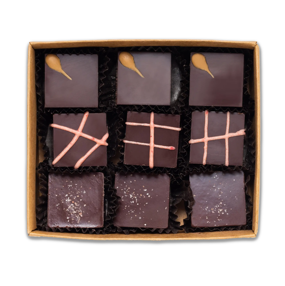 The interior of Raaka's truffle box with nine truffles total, three of each flavor: Winter Spice, Pomegranate, and Olive OIl. 