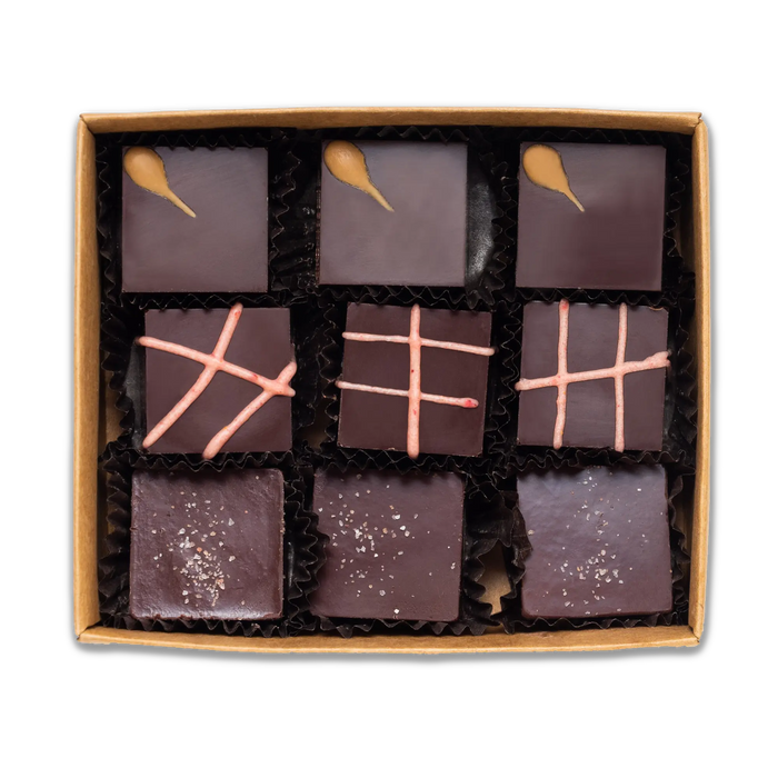 The interior of Raaka's truffle box with nine truffles total, three of each flavor: Winter Spice, Pomegranate, and Olive OIl. 