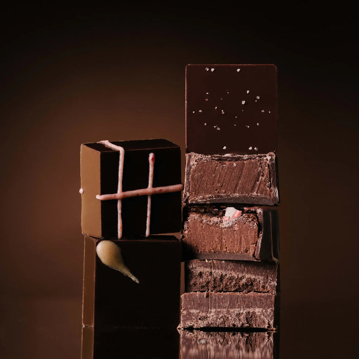 Raaka truffles stacked against a faded background.