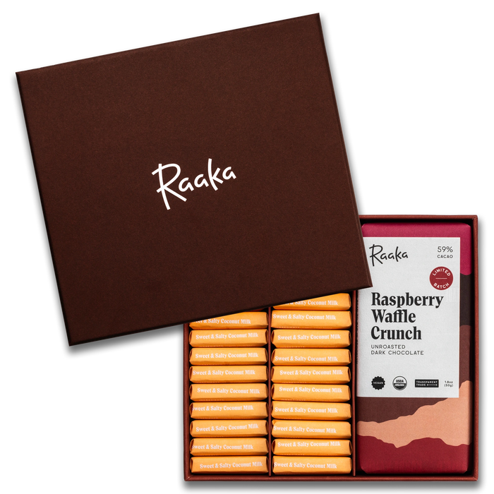 Open box of Raaka chocolate bars with a single Raspberry Waffle Crunch bar displayed.