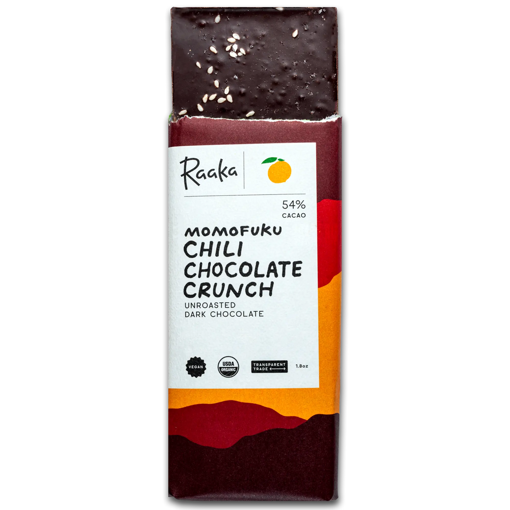 Chili Chocolate Crunch bar popping out of wrapper. Bar is garnished with salt and sesame seeds and has puffed quinoa. 
