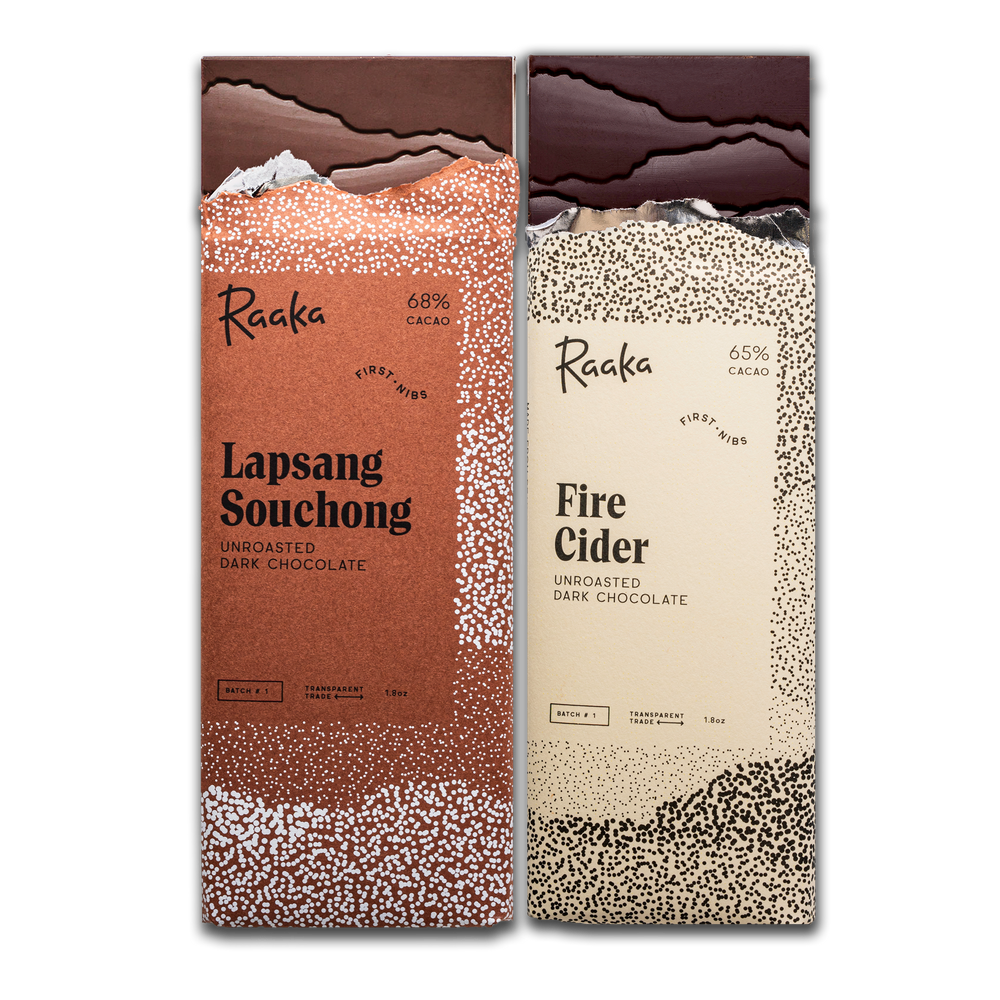 Two Raaka chocolate bars, in October's First Nibs batch: one 'Lapsang Souchong' and the other 'Fire Cider', on a white background.
