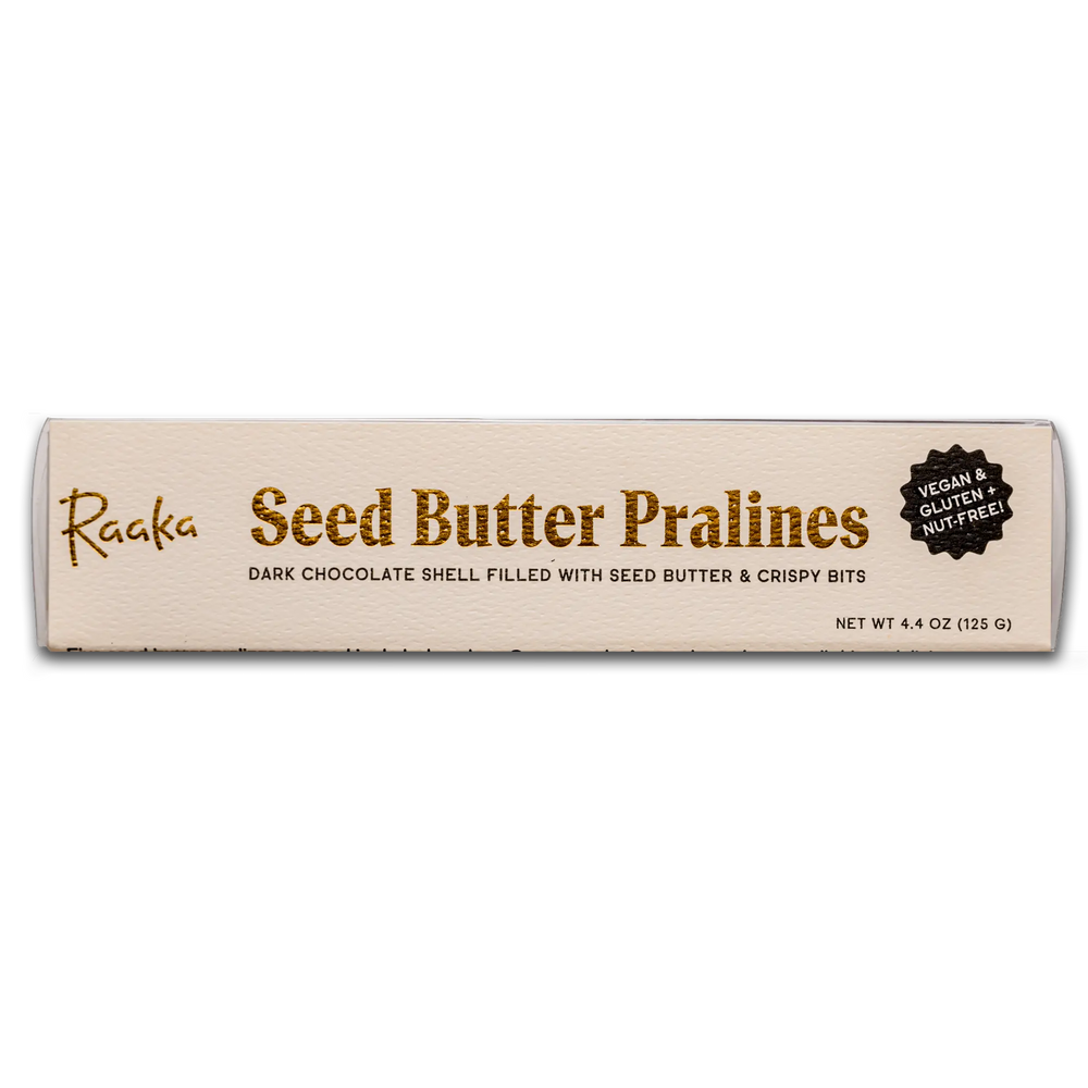 Seed Butter Praline Cube Package: metallic lettering on textured craft label. Cubes are in a plastic box with the label on it.
