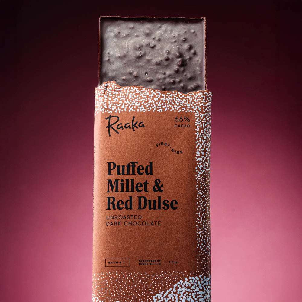 Dark chocolate bar with Raaka packaging on a purple background