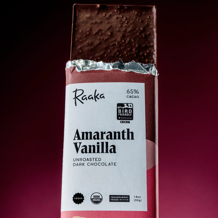 Raaka Amaranth Vanilla dark chocolate bar on a red background