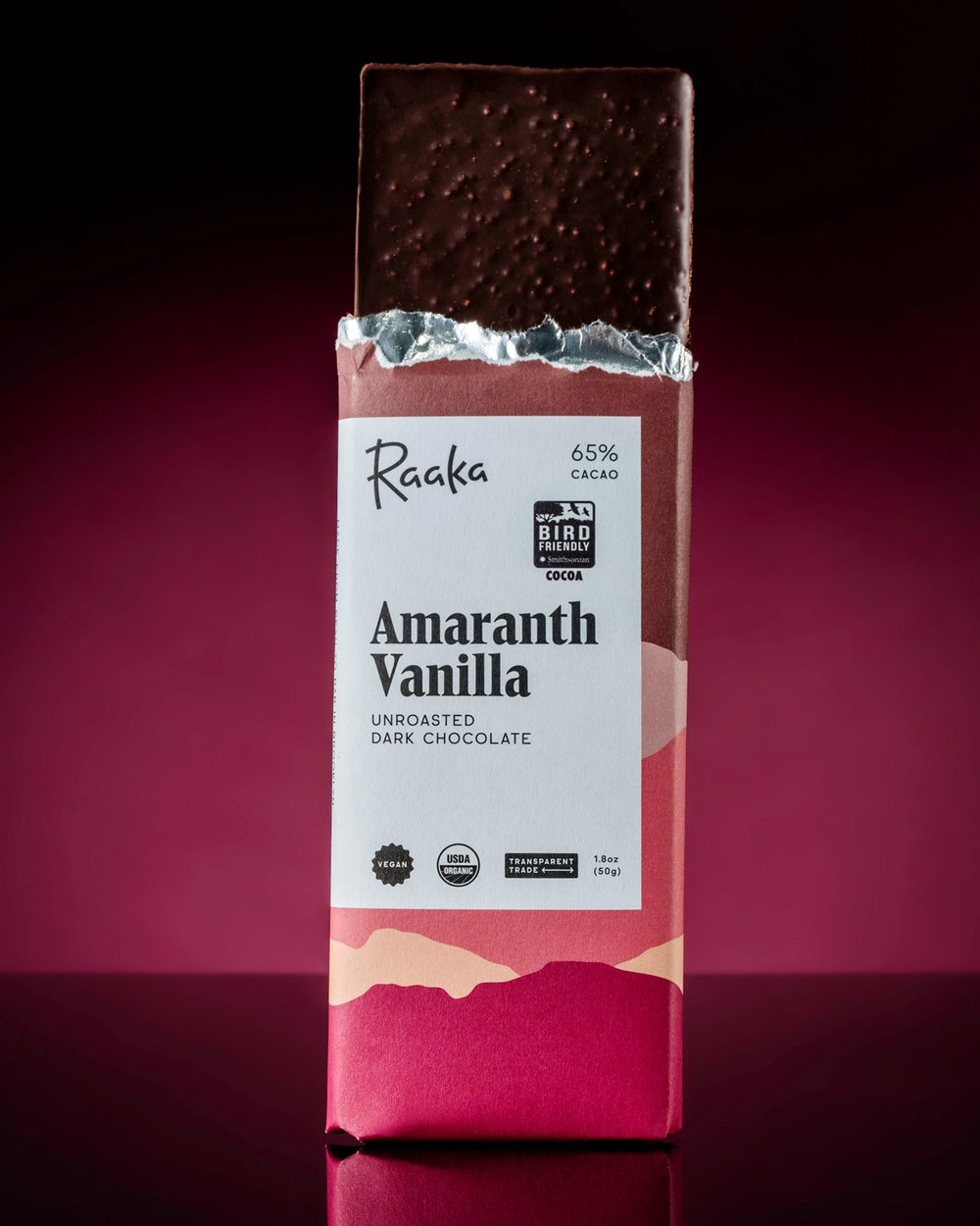 Raaka Amaranth Vanilla unroasted dark chocolate bar on a dark background