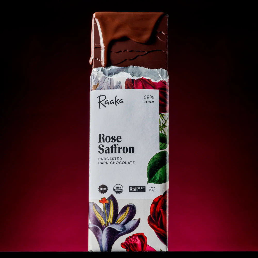 Raaka Rose Saffron chocolate bar with a dark red background