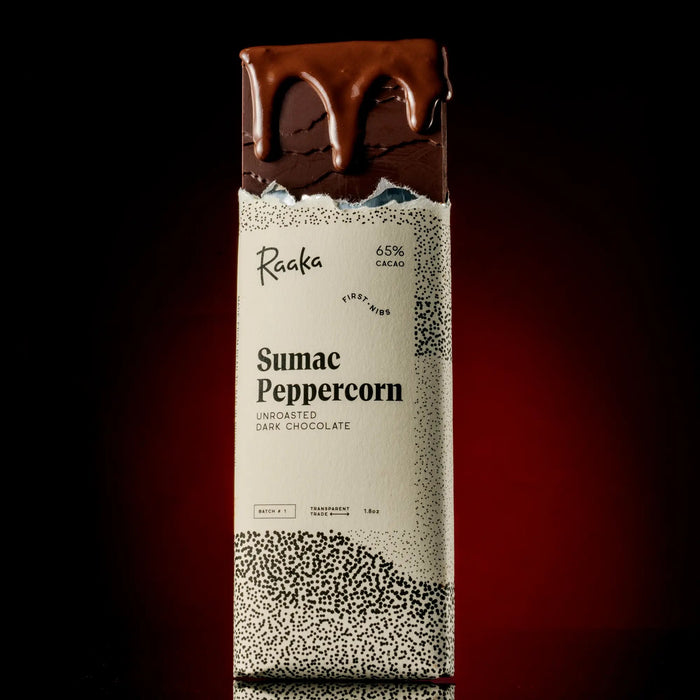 Raaka Sumac Peppercorn dark chocolate bar with a dark background