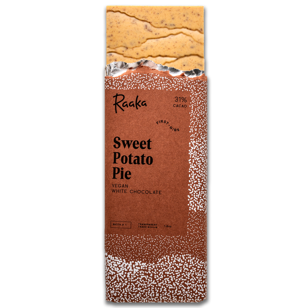 Sweet Potato Pie bar popping out wrapper. Bar is orange tinted and filled with bits of pumpkin spice cookies.