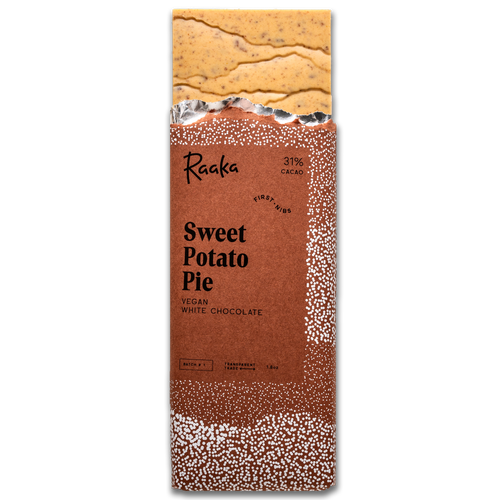 Sweet Potato Pie bar popping out wrapper. Bar is orange tinted and filled with bits of pumpkin spice cookies.