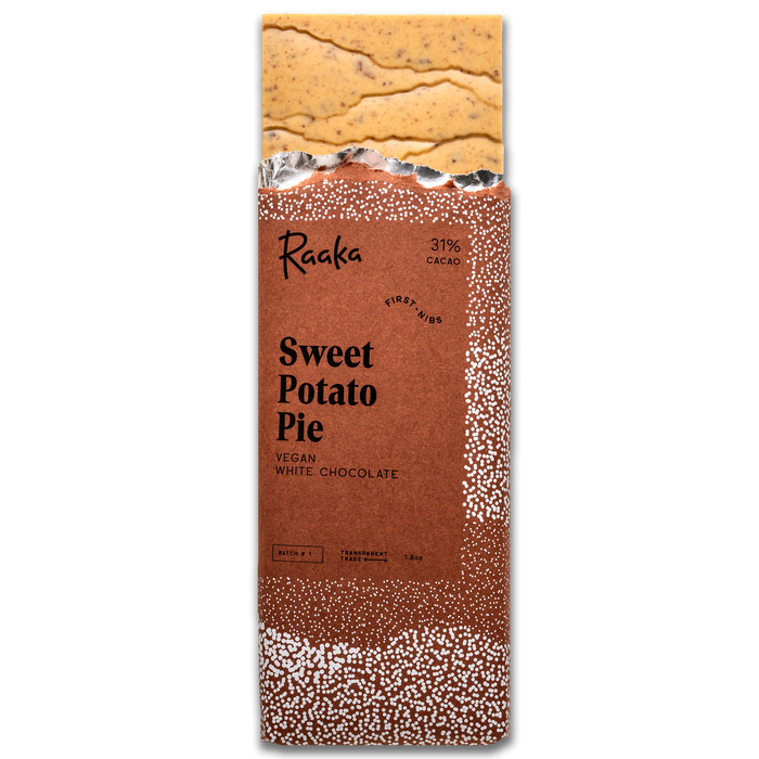Sweet Potato Pie bar popping out wrapper. Bar is orange tinted and filled with bits of pumpkin spice cookies.