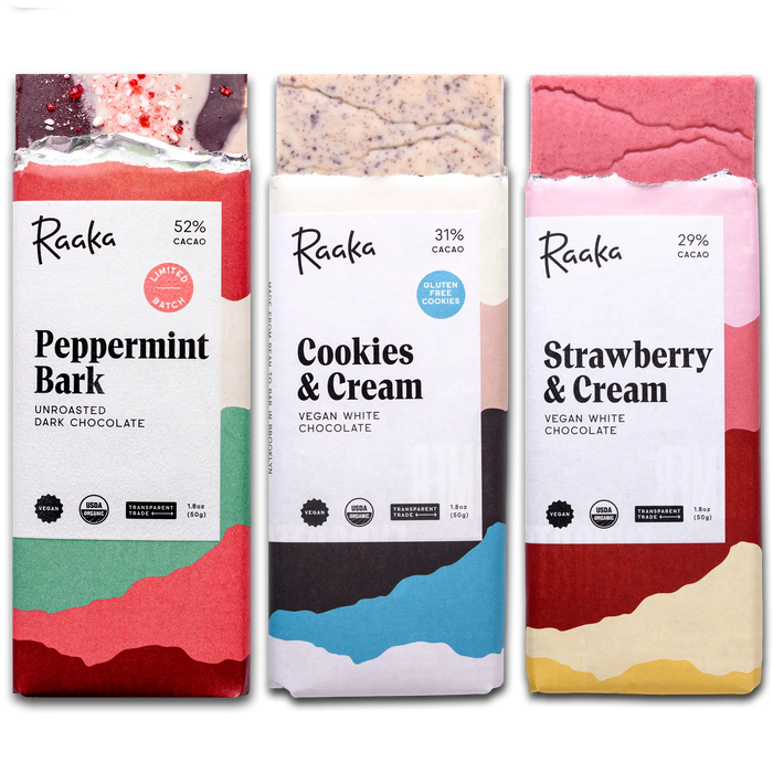 Three Raaka white chocolate bars on a white background: Peppermint Bark, Cookies and Cream, and Strawberry & Cream.
