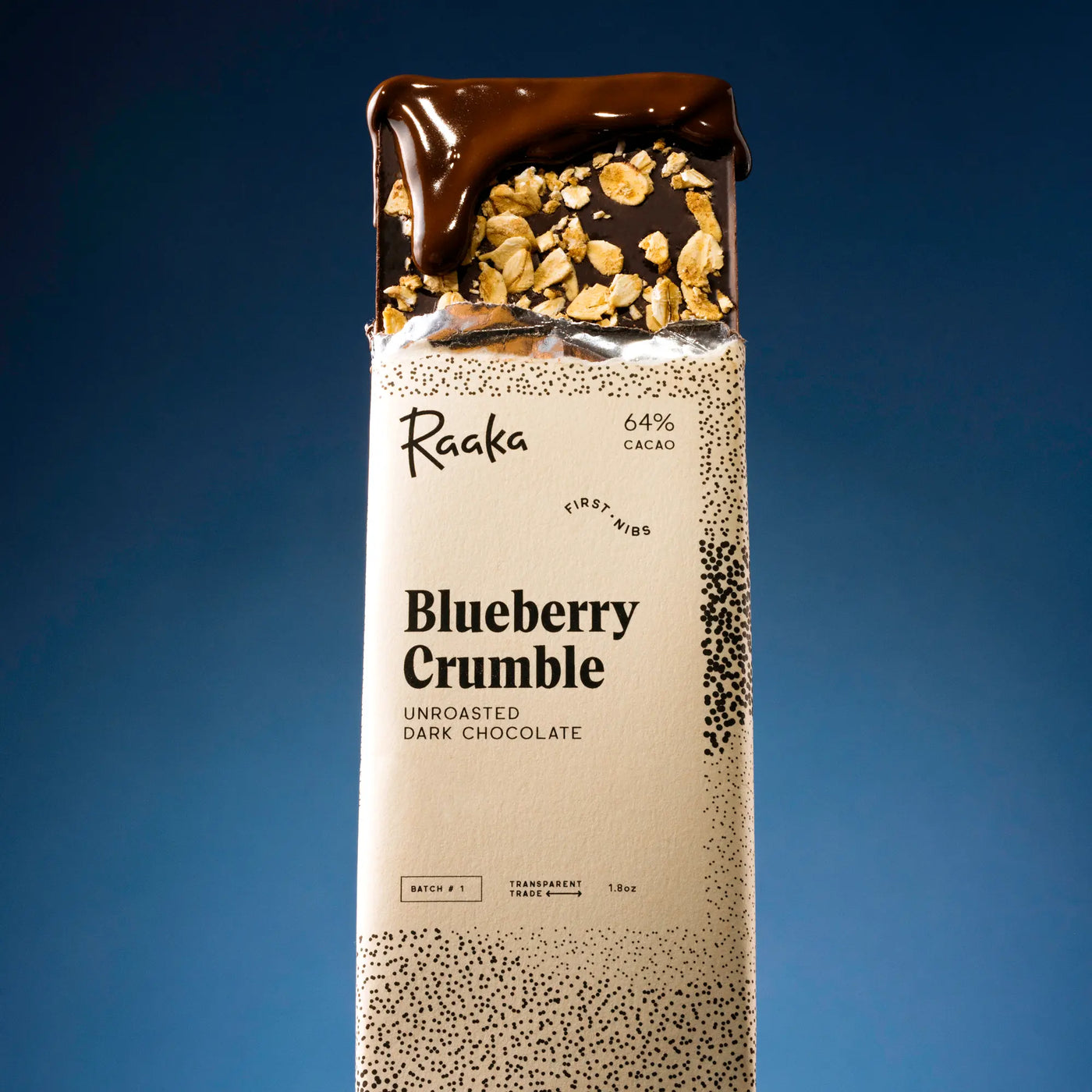 Raaka Blueberry Crumble chocolate bar packaging on a blue background